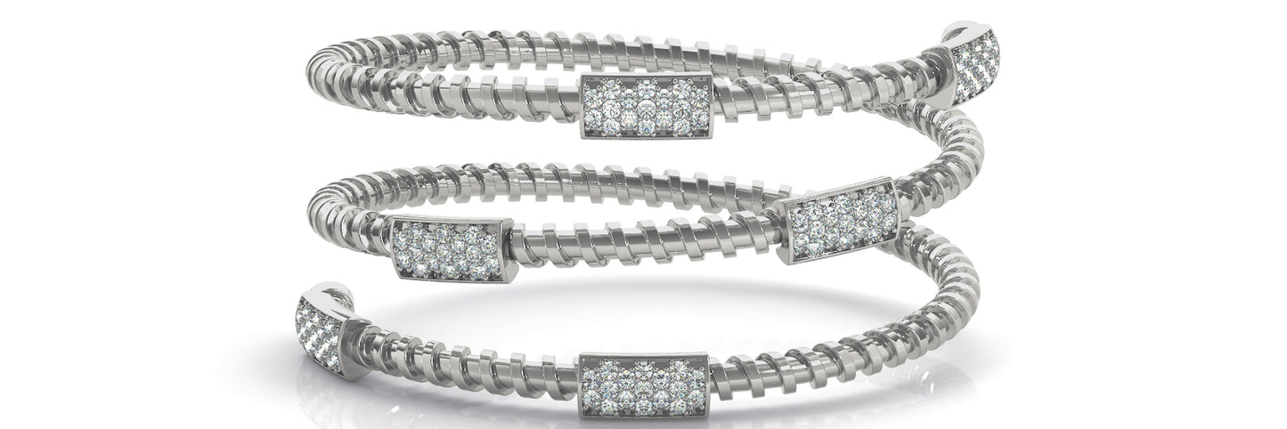 Three white gold coiled bracelets with diamond-encrusted clasps displayed against a white background, exuding elegance and luxury.