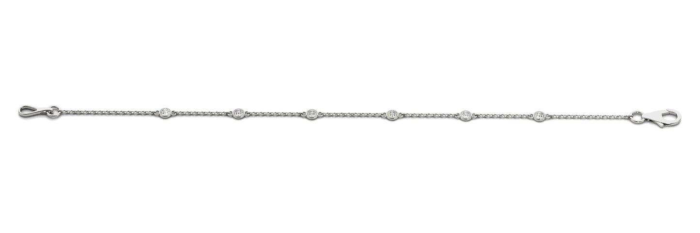 A delicate white gold chain bracelet with evenly spaced round diamonds, featuring a hook clasp, displayed on a plain white background.