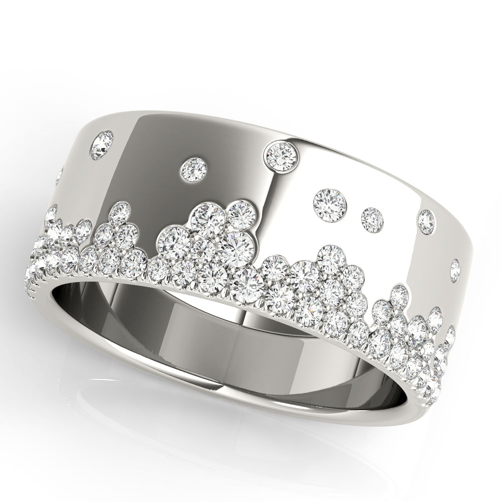 A white gold ring with a wide band is adorned with small, sparkling diamonds arranged in a scattered cluster pattern. The tone is luxurious and elegant.