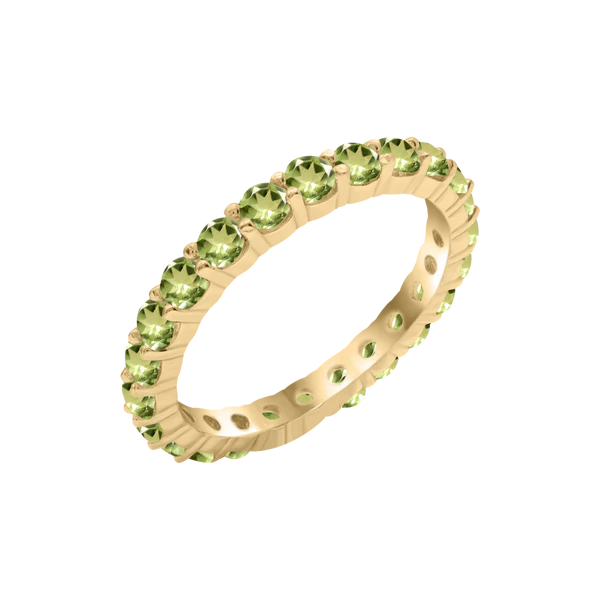 A gold ring with small period gemstones inlaid around the band, displayed on a transparent checkered background, showcasing elegance and luxury.