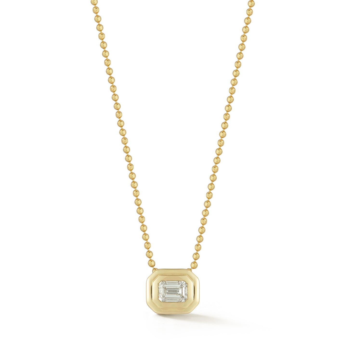 A gold chain necklace with a emerald diamond pendant set in a gold bezel, displayed against a white background, conveying elegance and simplicity.