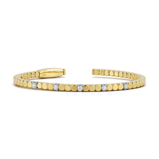 A sleek open bracelet with round, polished gold links interspersed with evenly spaced, sparkling small diamonds, conveying elegance and sophistication.
